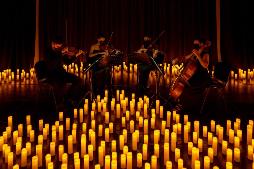 violinists performing at a candlelight concert
