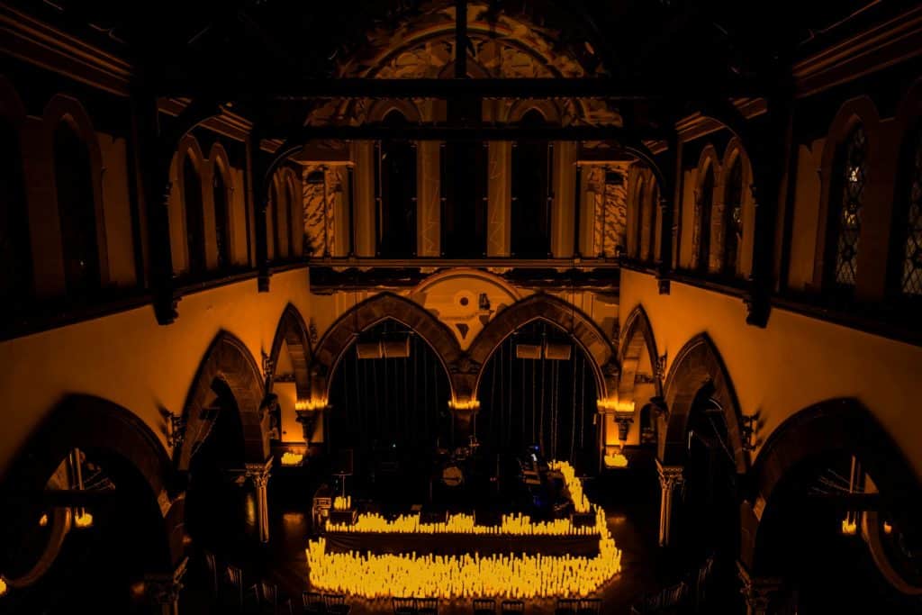 The interior of Òran Mór bathed in the glow of hundreds of candles for a Candlelight concert.