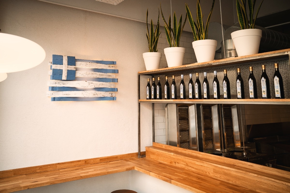 gyros-glasgow-interior-with-greek-flag-and-shelves-with-olive-oil-bottles