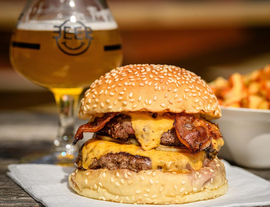glass of beer and big cheesburger