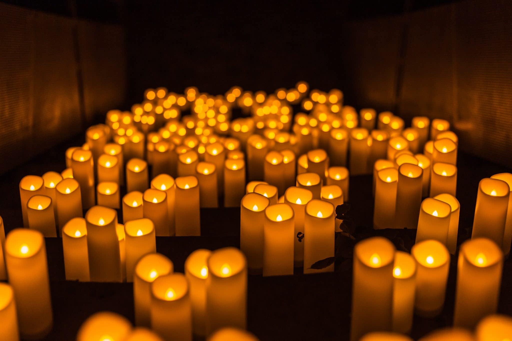 a sea of flameless candles decorate The Platform