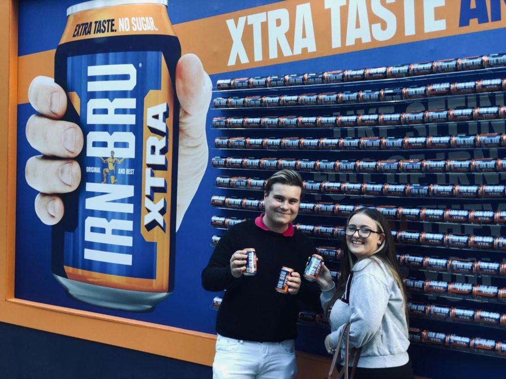 people holding free cans of irn-bru
